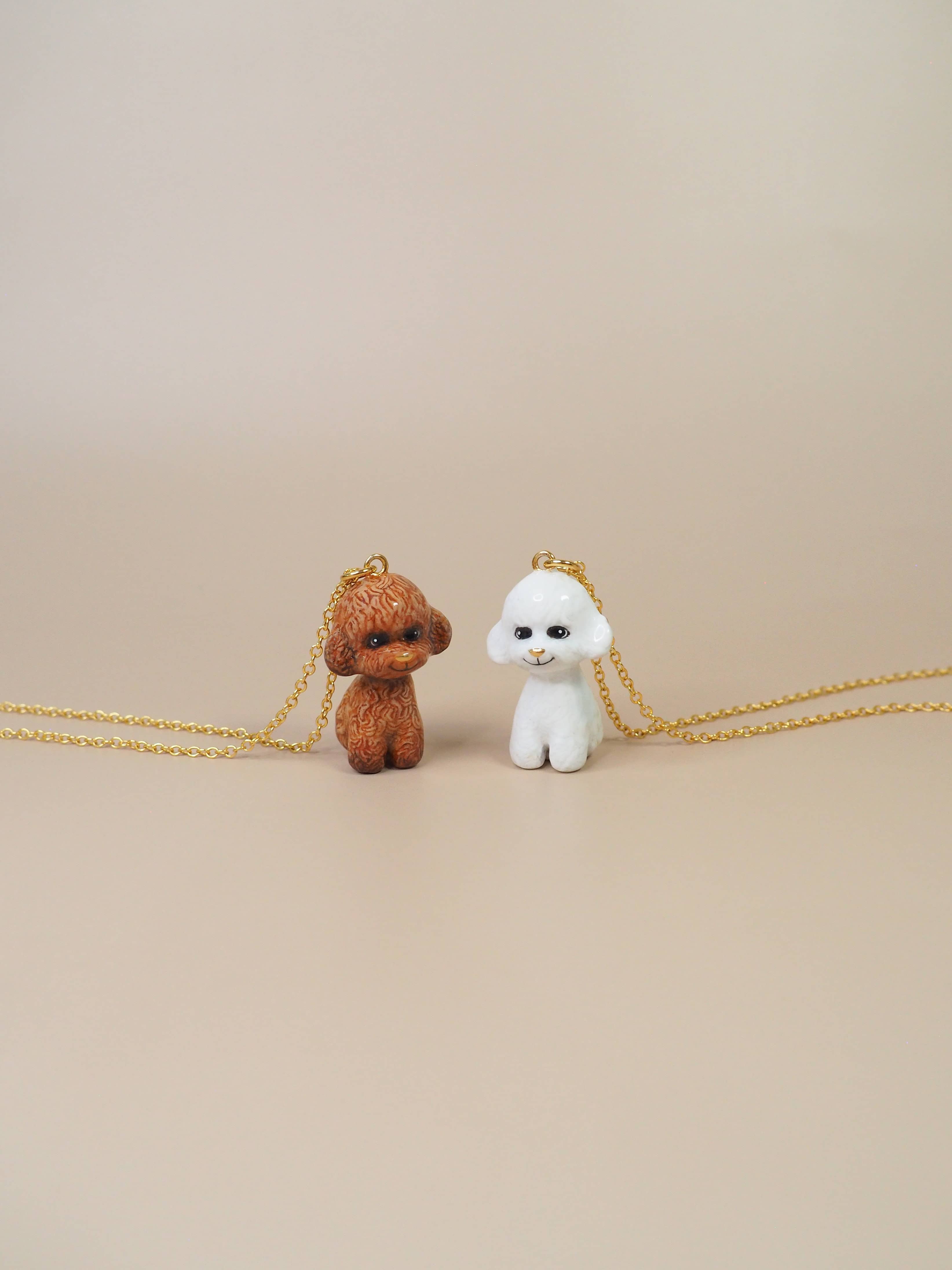 Two charming poodle pendant with gold necklace showcasing a white and brown poodle.