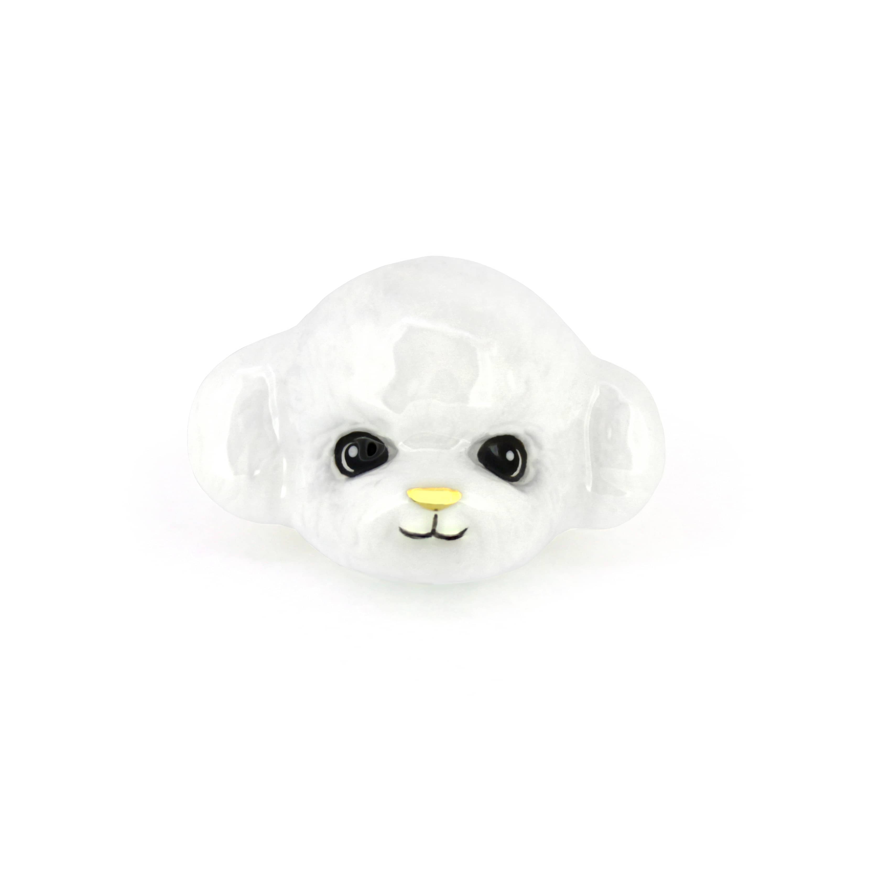 Cute white poodle ring with a smiling face, perfect for dog lovers.