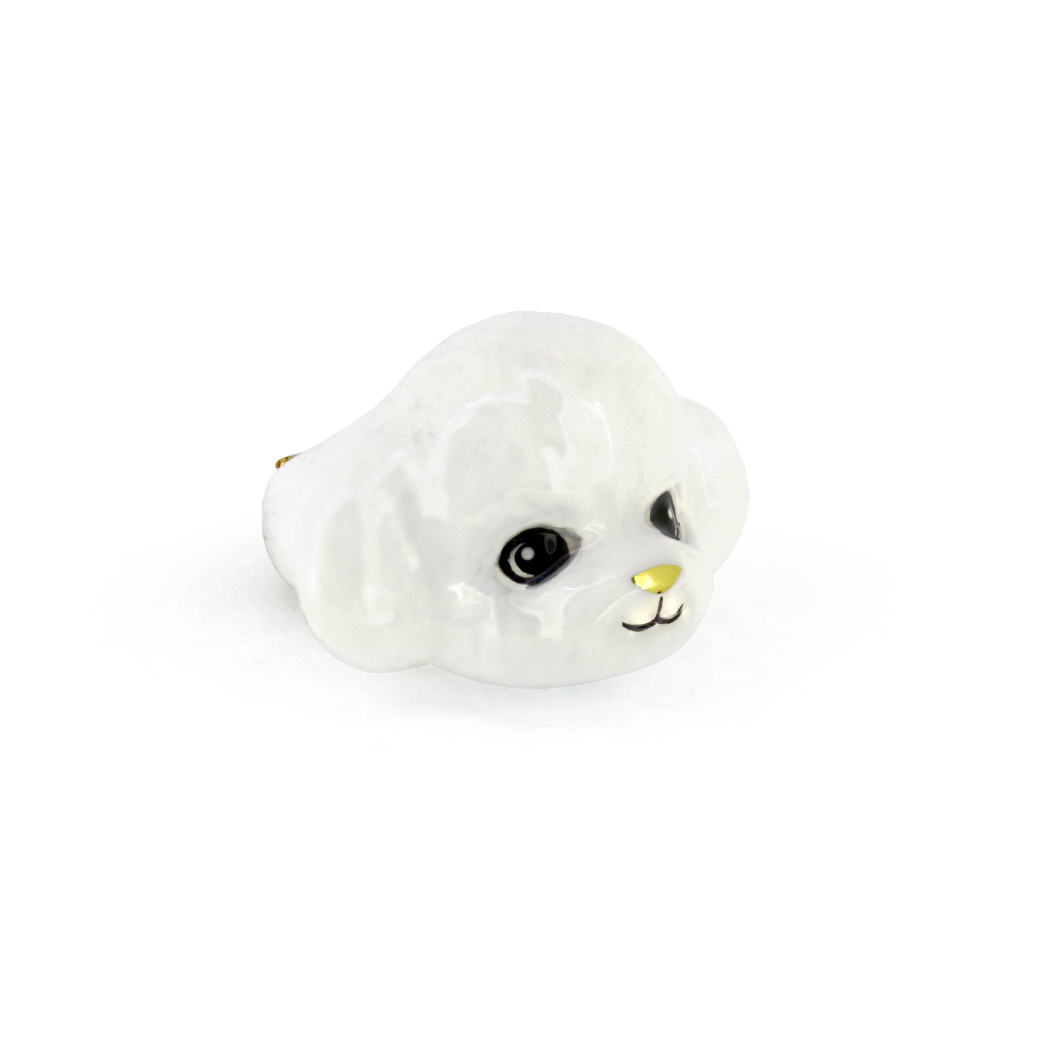 Adorable white poodle ring, perfect for dog lovers.