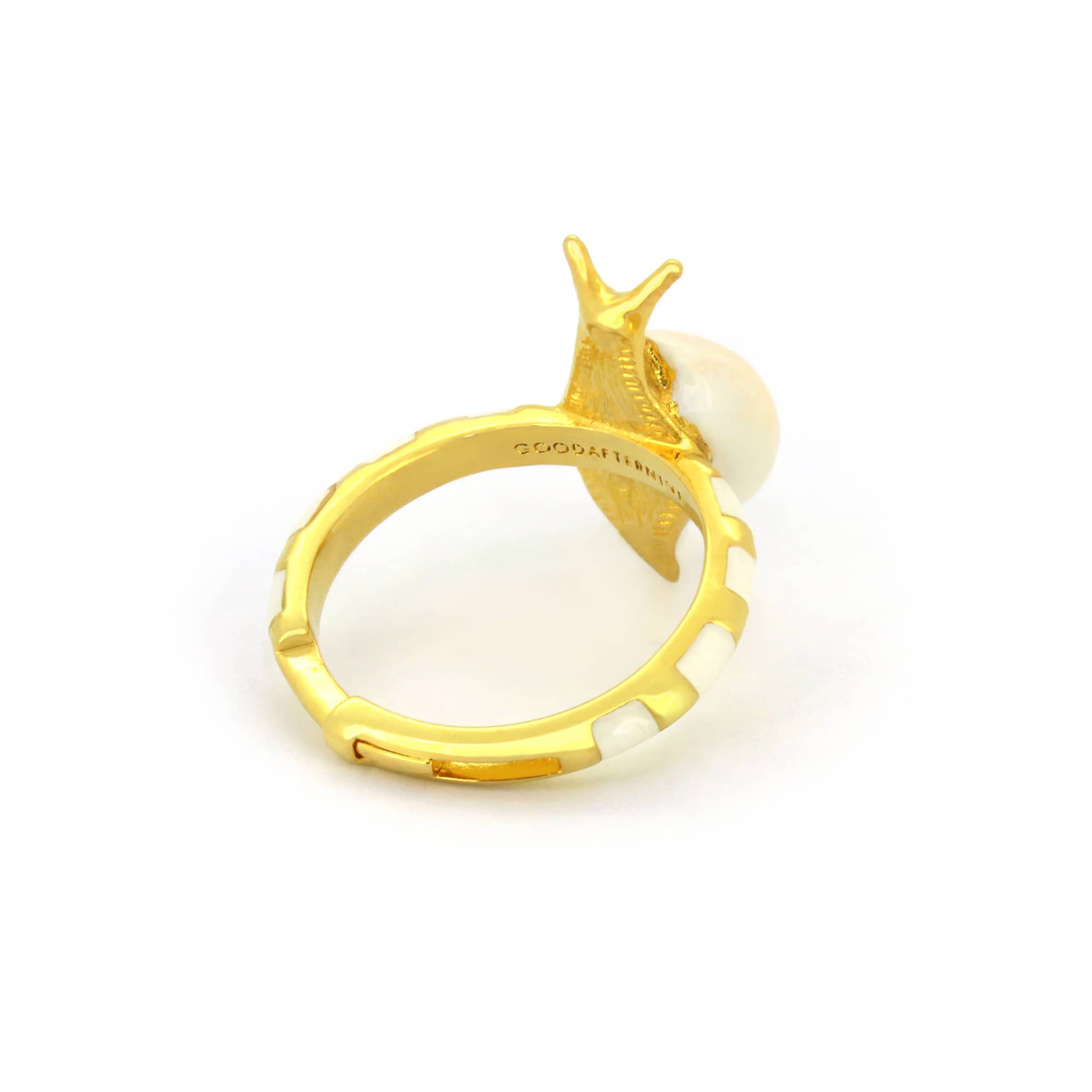 Nature-inspired gold ring designed as a snail, featuring a light pink shell.
