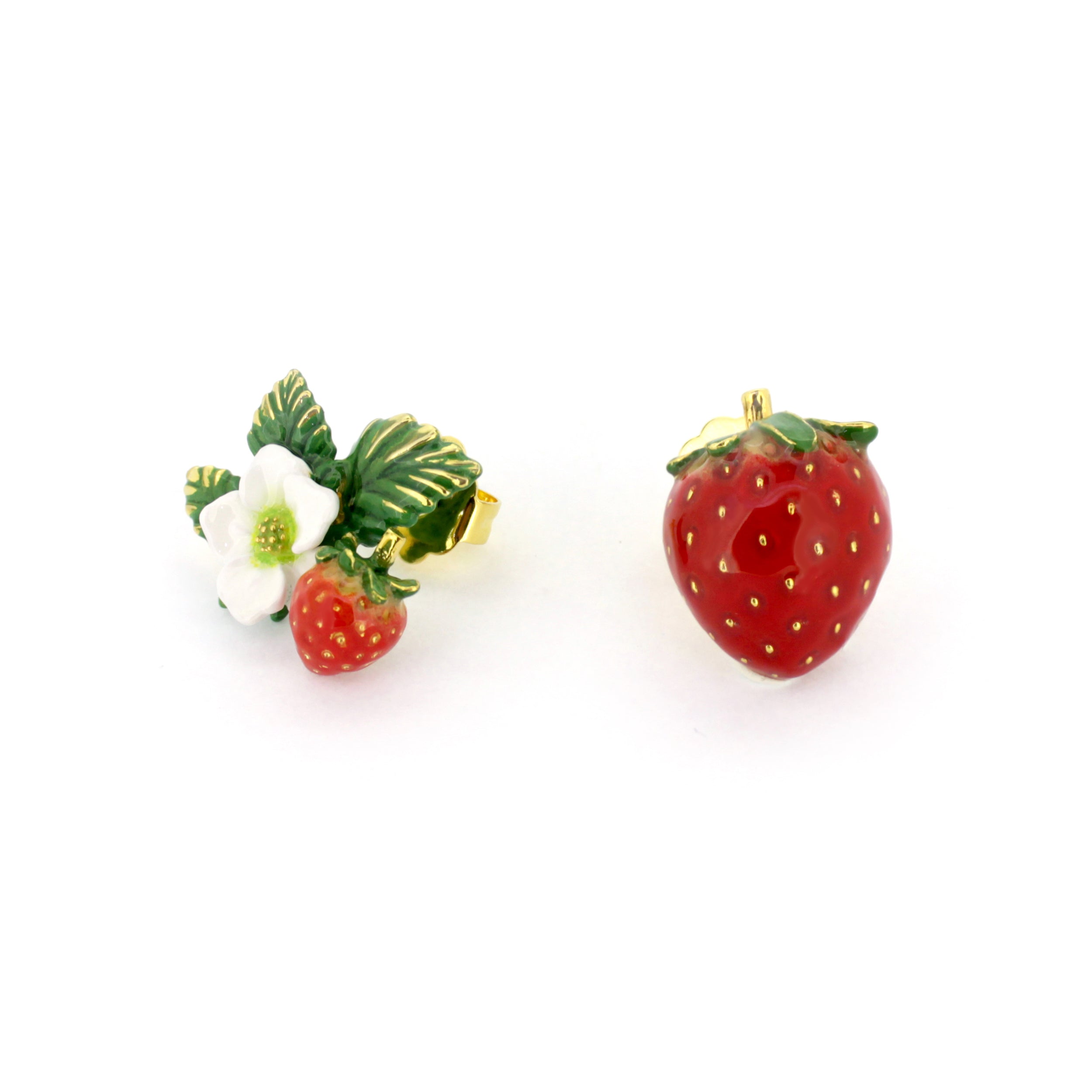 A pair of earrings designed with a red strawberry and a small white flower with green leaves.