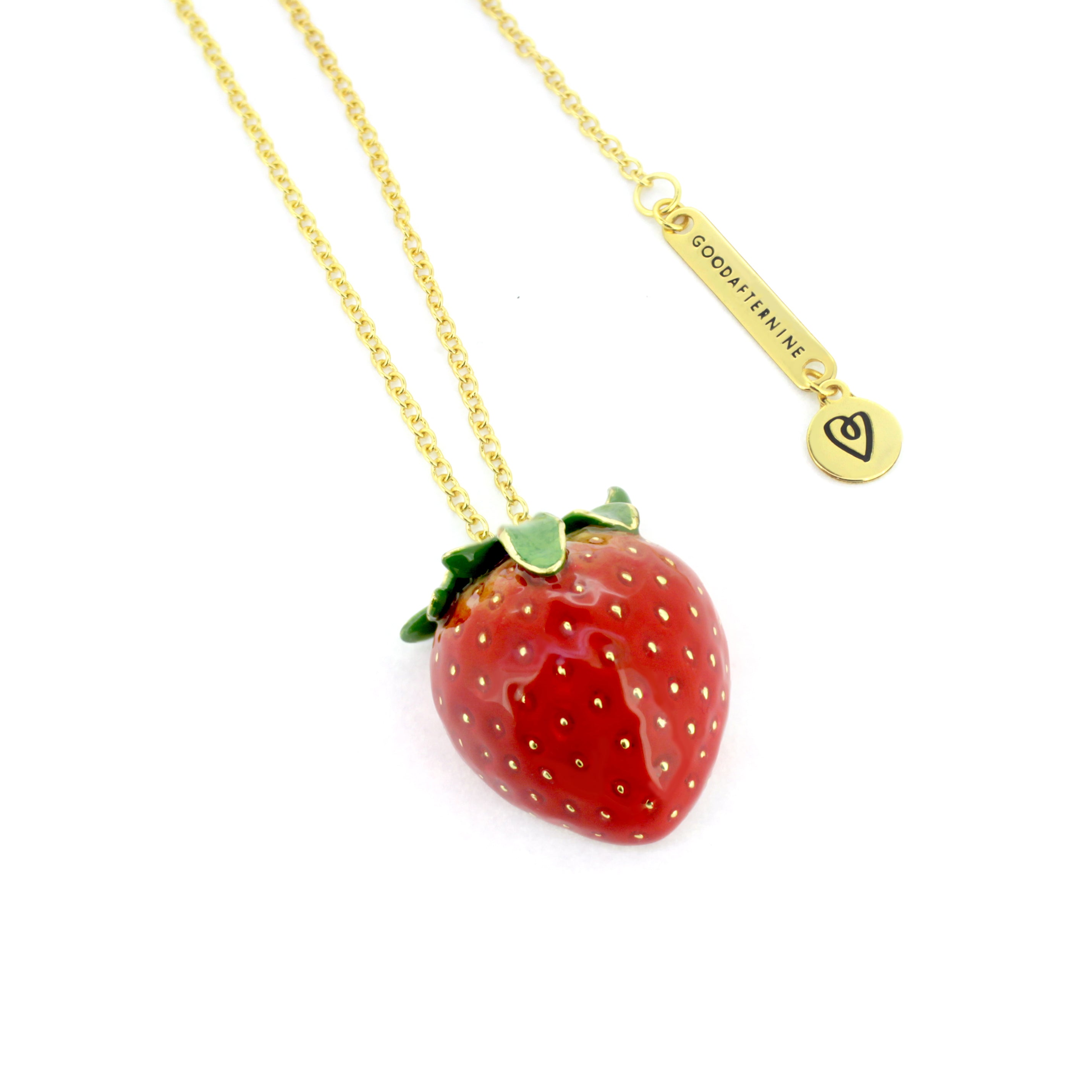 Handcrafted red strawberry pendant with a gold chain necklace, inspired by nature.