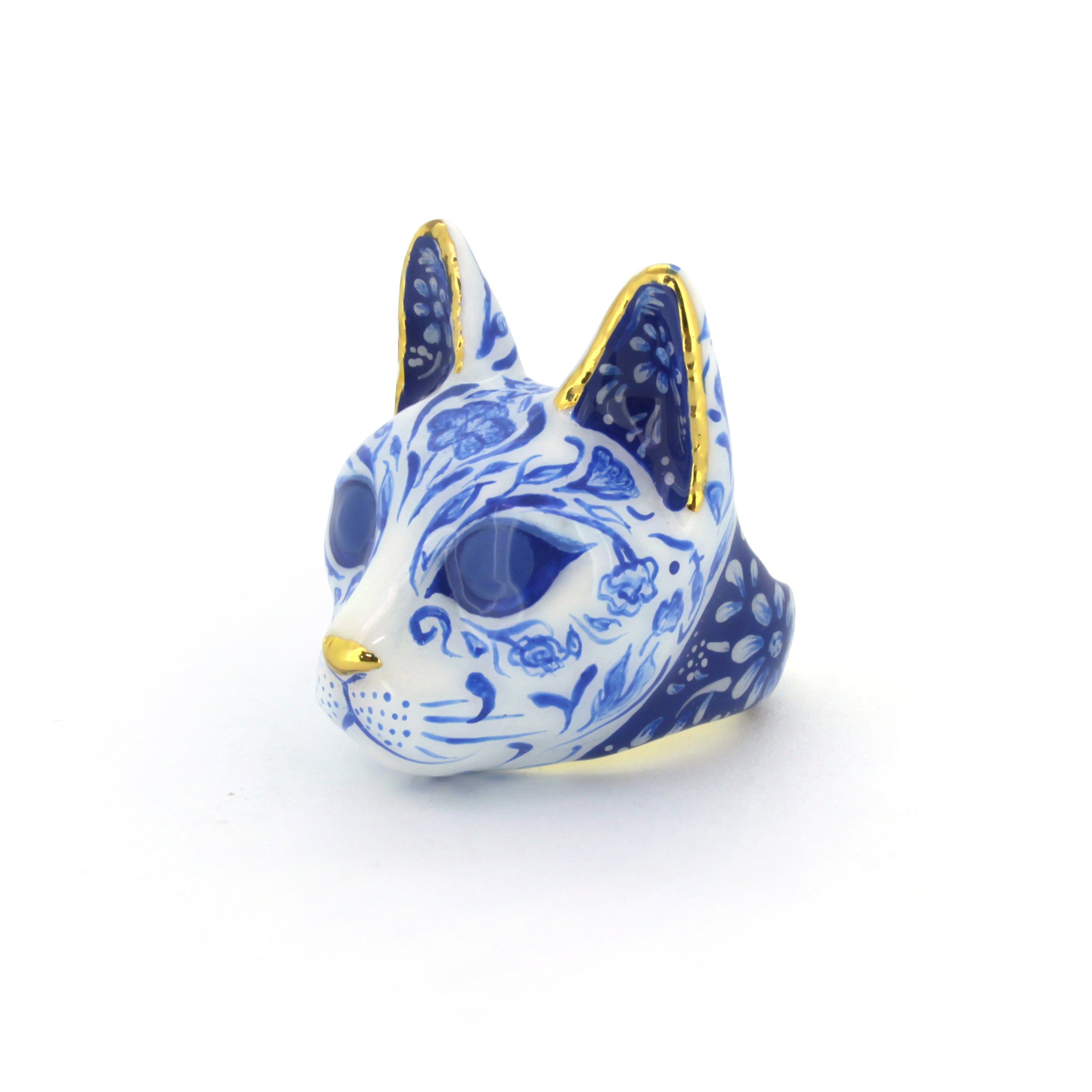 Unique cat ring featuring detailed porcelain patterns, painted in blue and white pattern with gold accents, perfect for art collectors.
