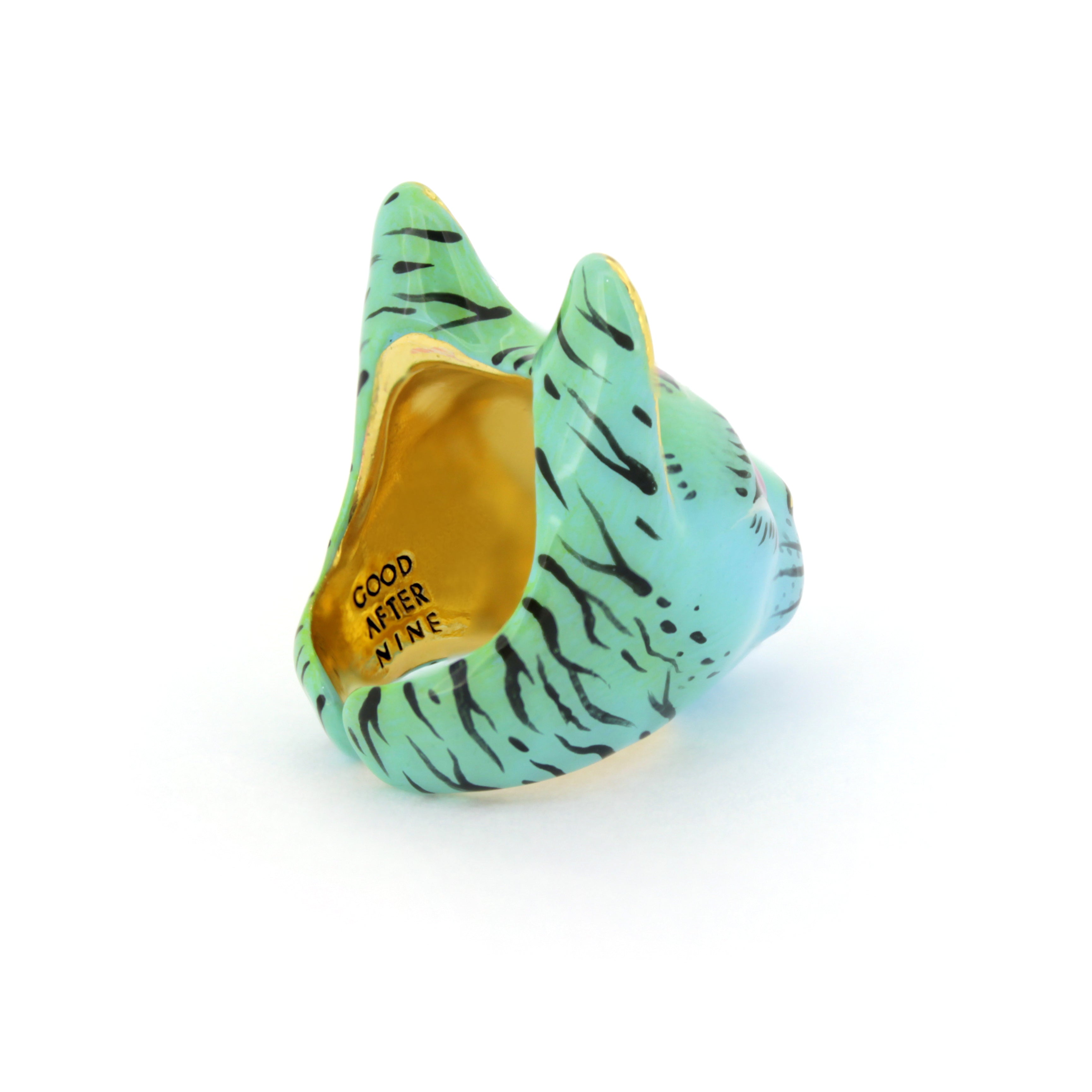 A green cat-shaped ring with black stripes, featuring the inscription "GOOD AFTER NINE" inside.