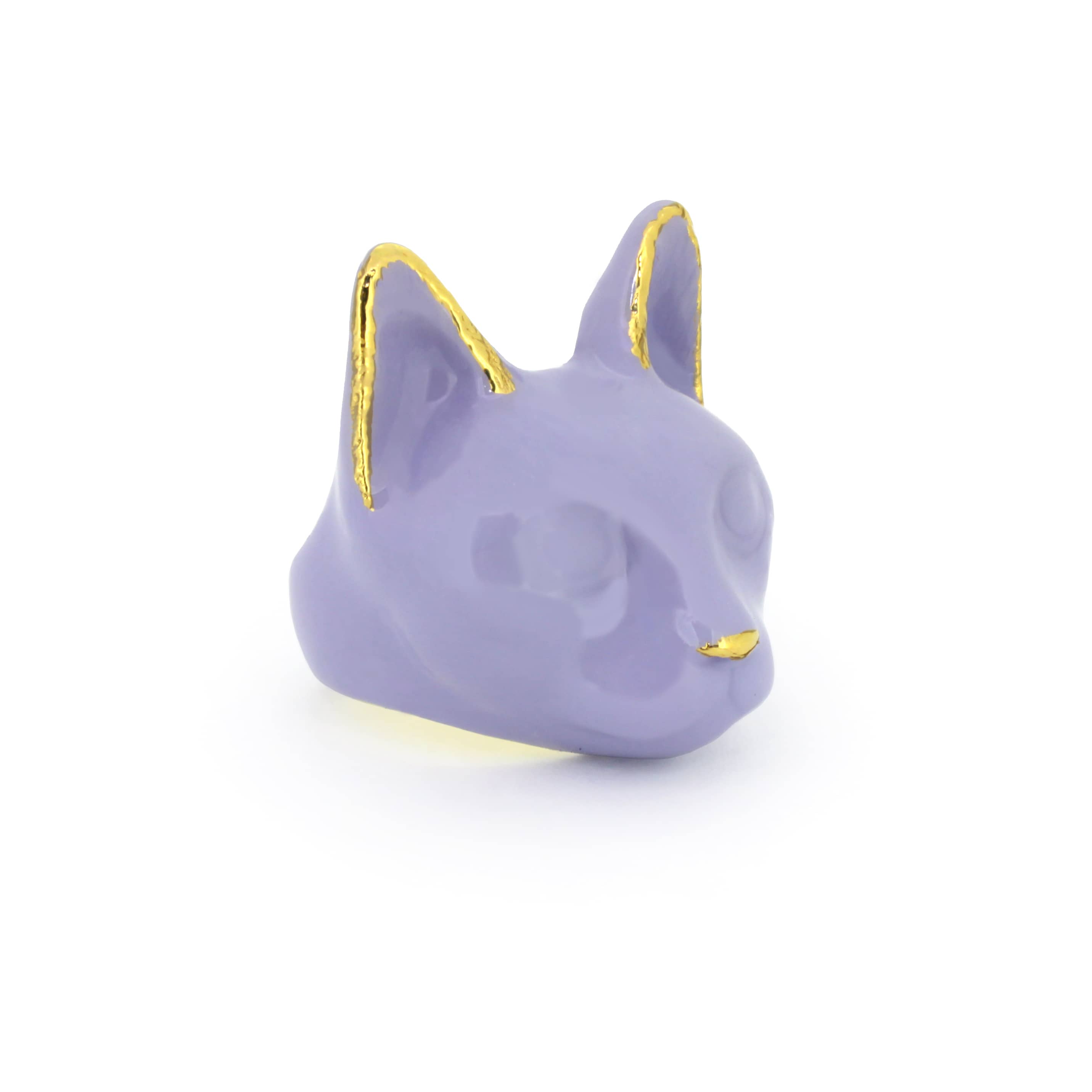 A whimsical ring designed in the shape of a cat’s head, featuring a soft lavender color.