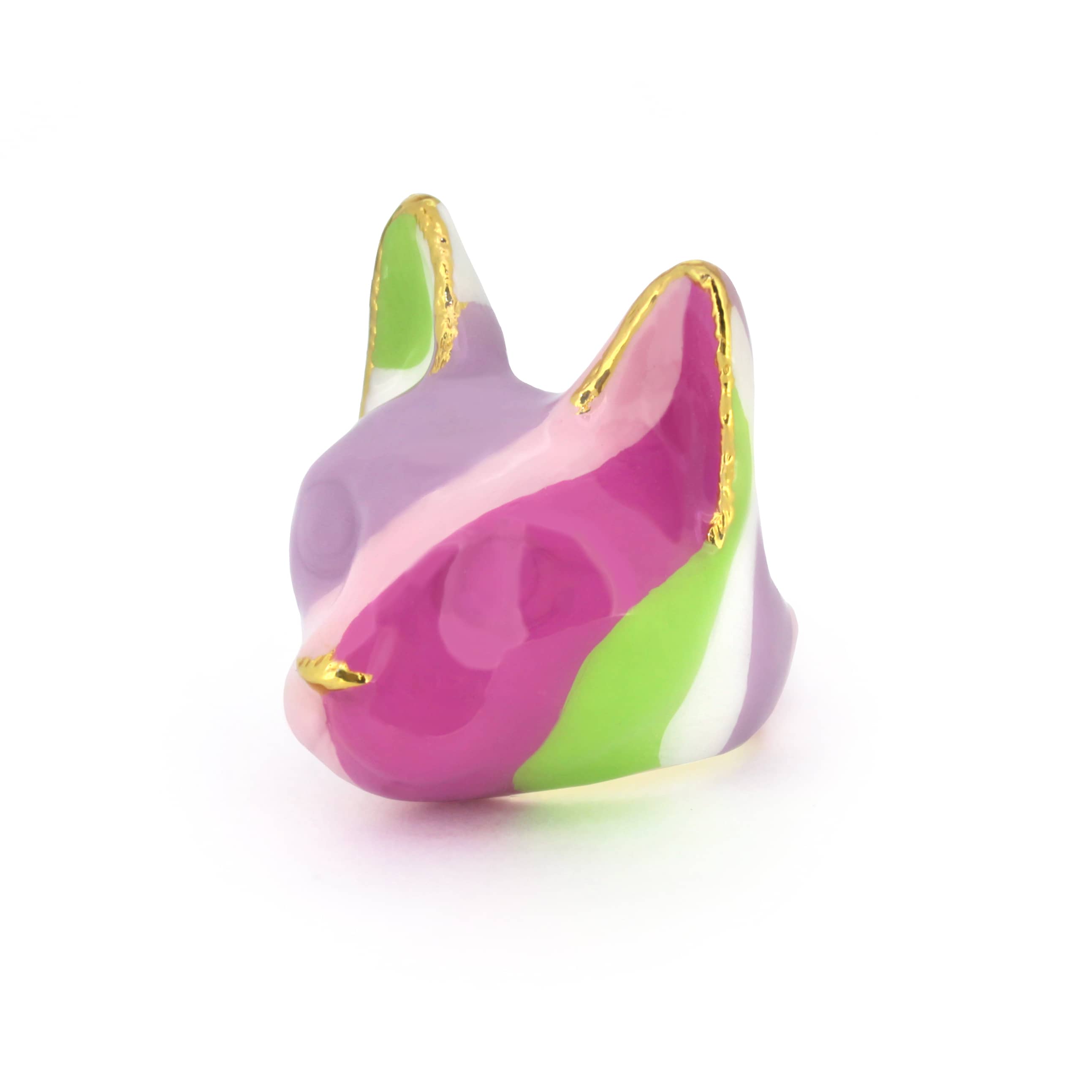 A colorful cat's head ring with geometric shapes in purple, pink, green, and white, accented by gold edges.