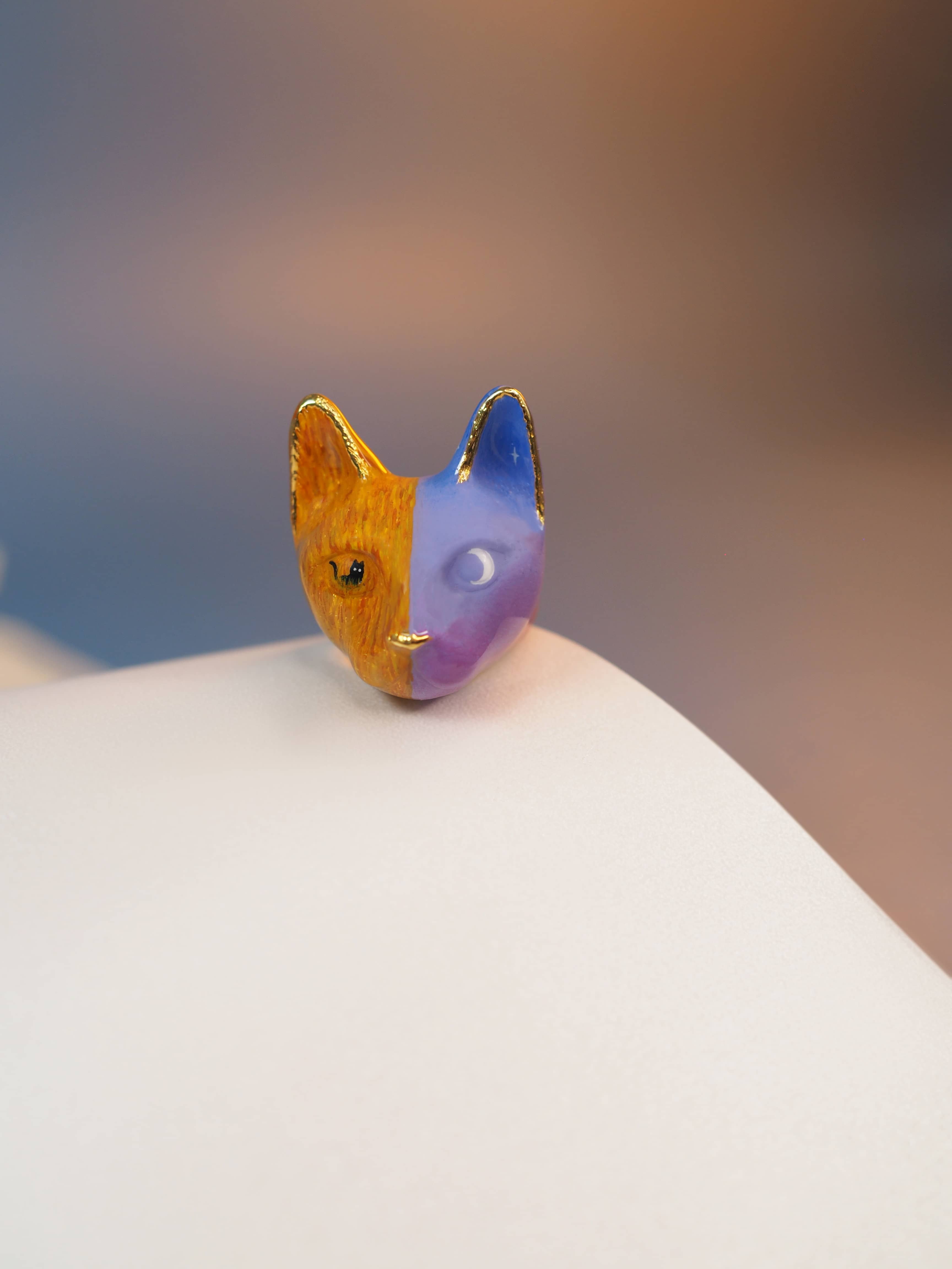 Charming hand-painted cat ring featuring a black cat in a field amidst a night sky and moon.