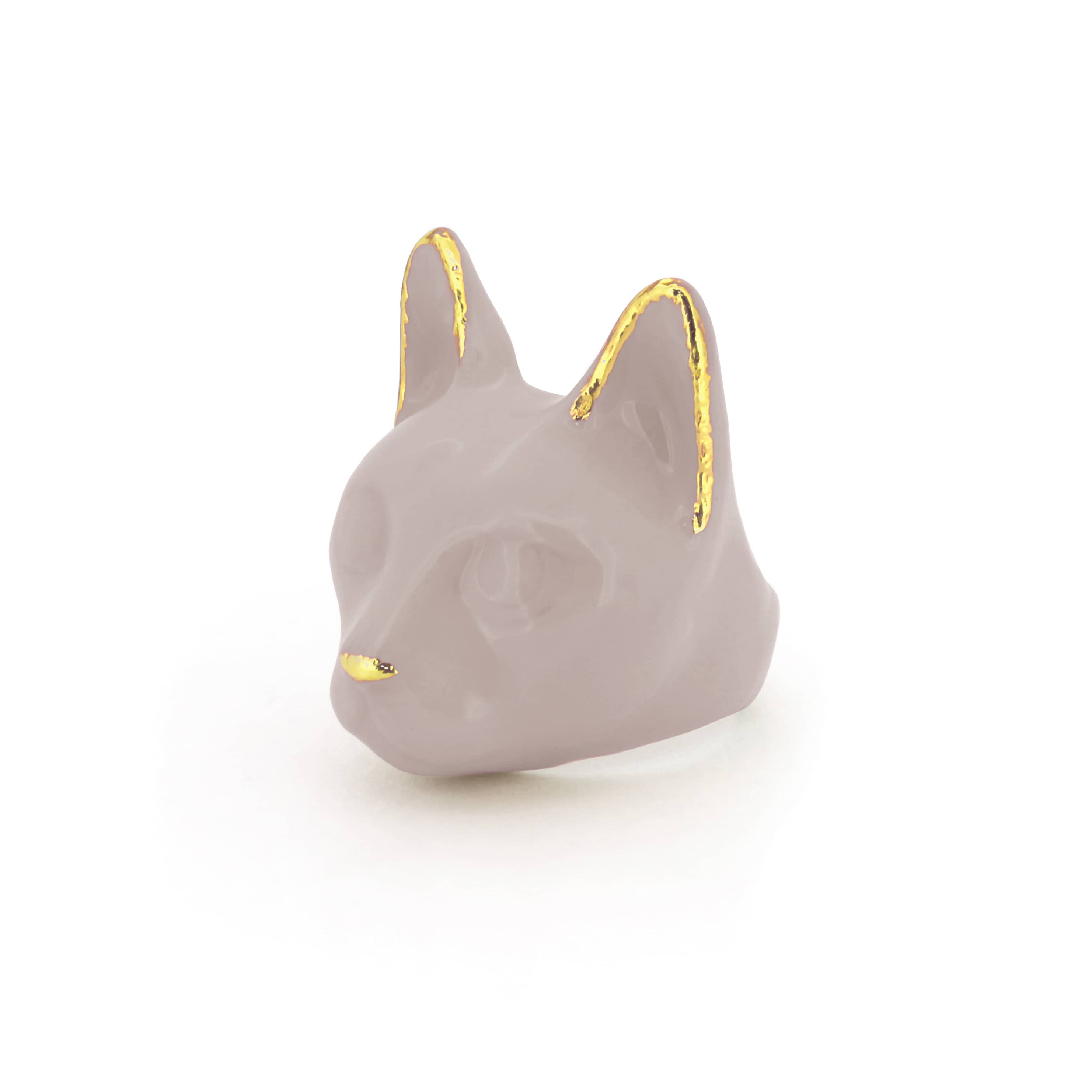 A dusty pink cat's head ring with gold accents on the ears and a small gold nose