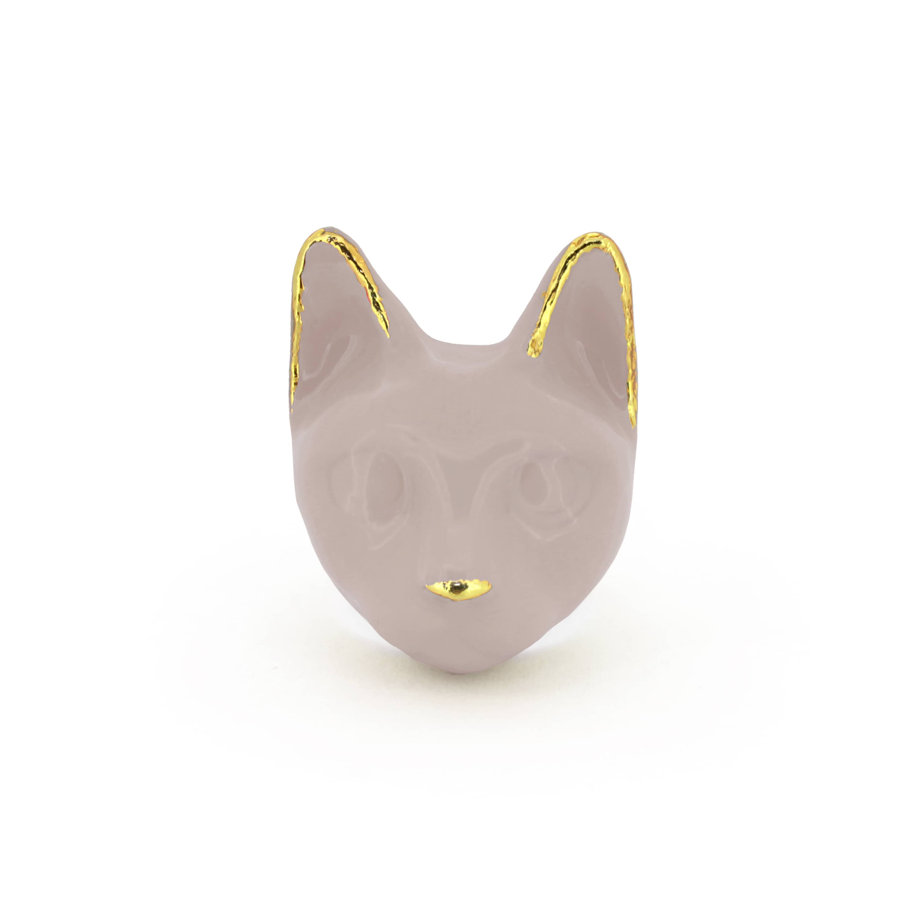 A dusty pink cat's head ring with gold accents on the ears and a small gold nose, perfect for cat lovers.