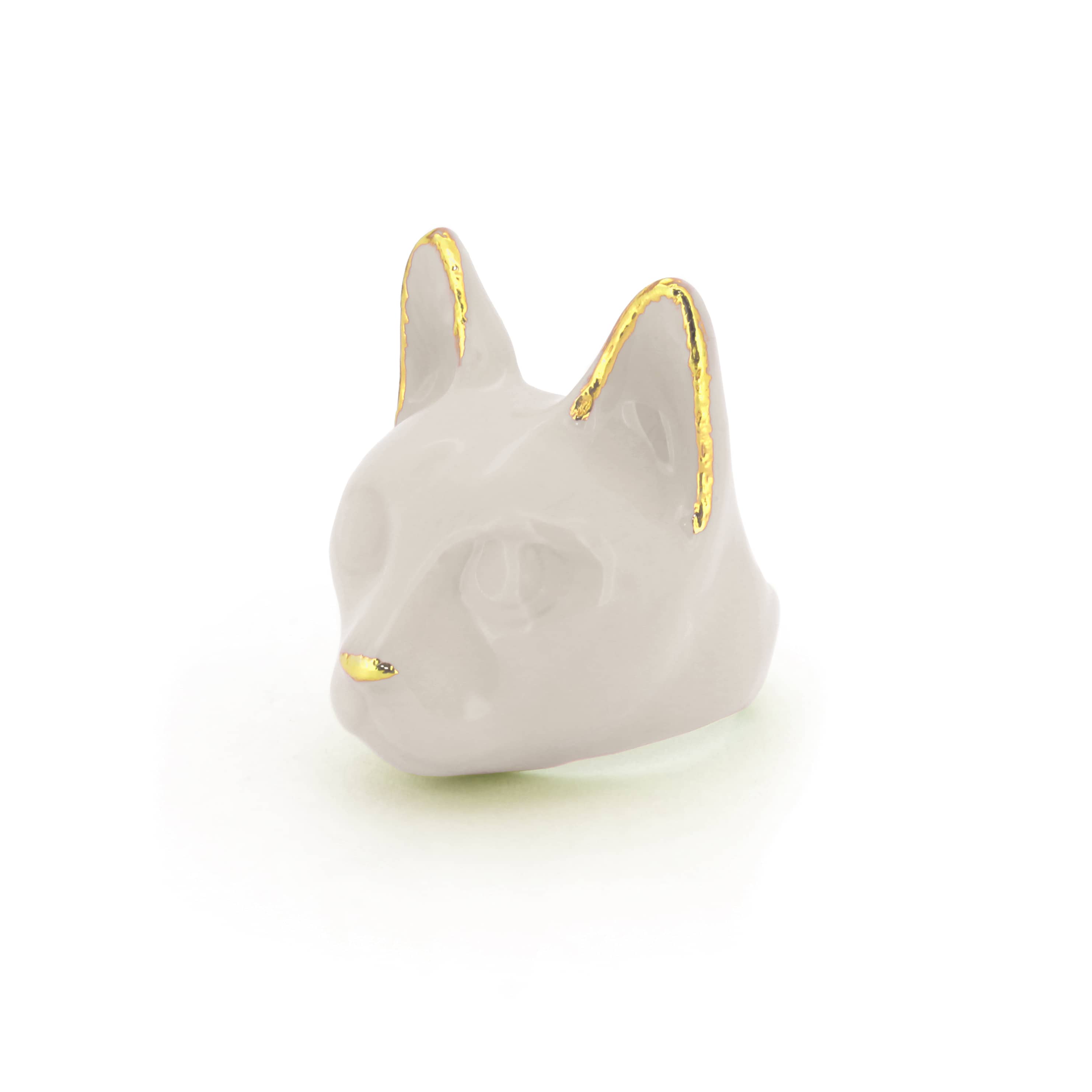 A pale gray cat's head ring with gold accents on the ears and a small gold nose, perfect for cat lovers.