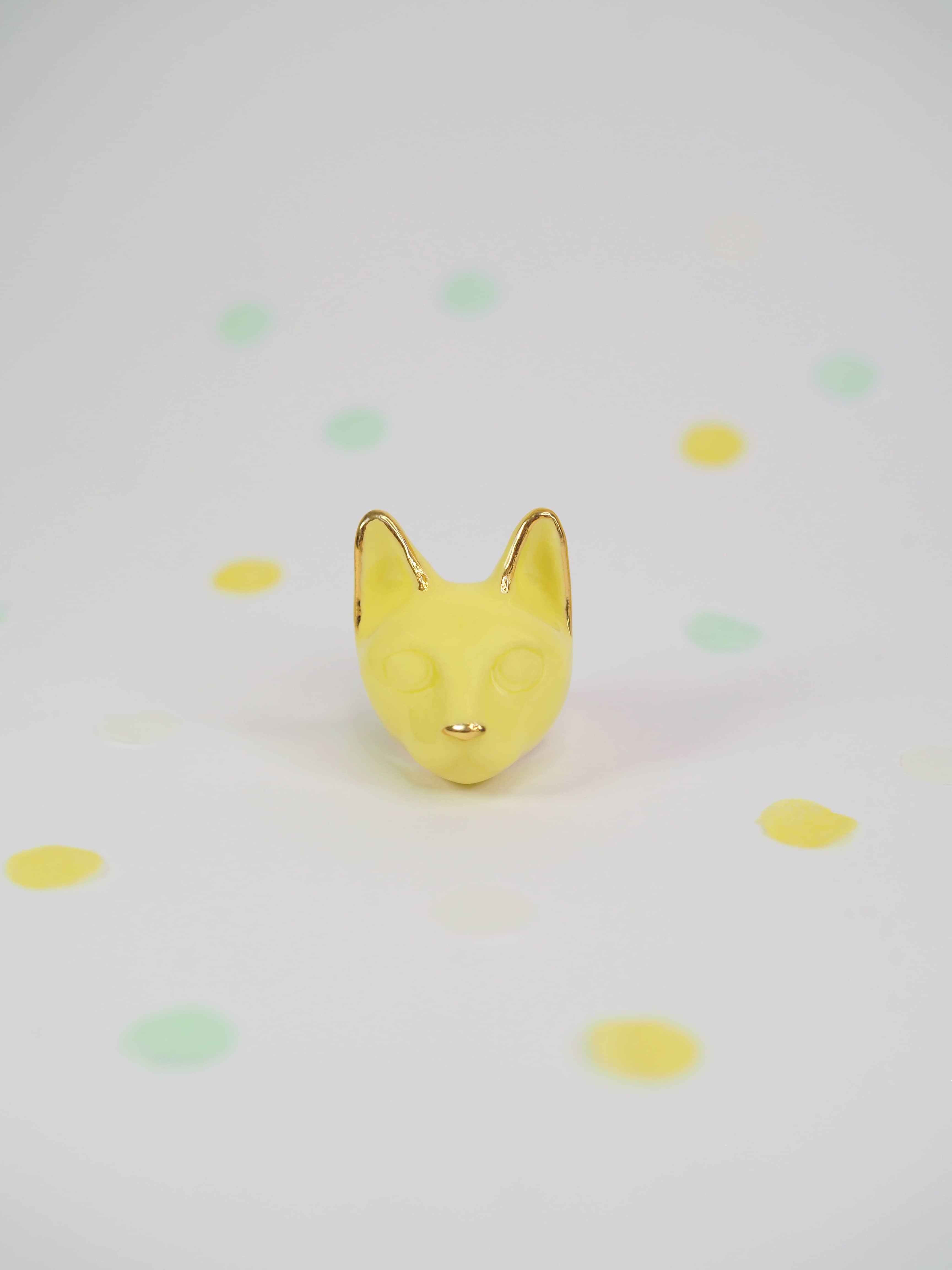 Yellow cat ring from the summer collection on a polka dot background.