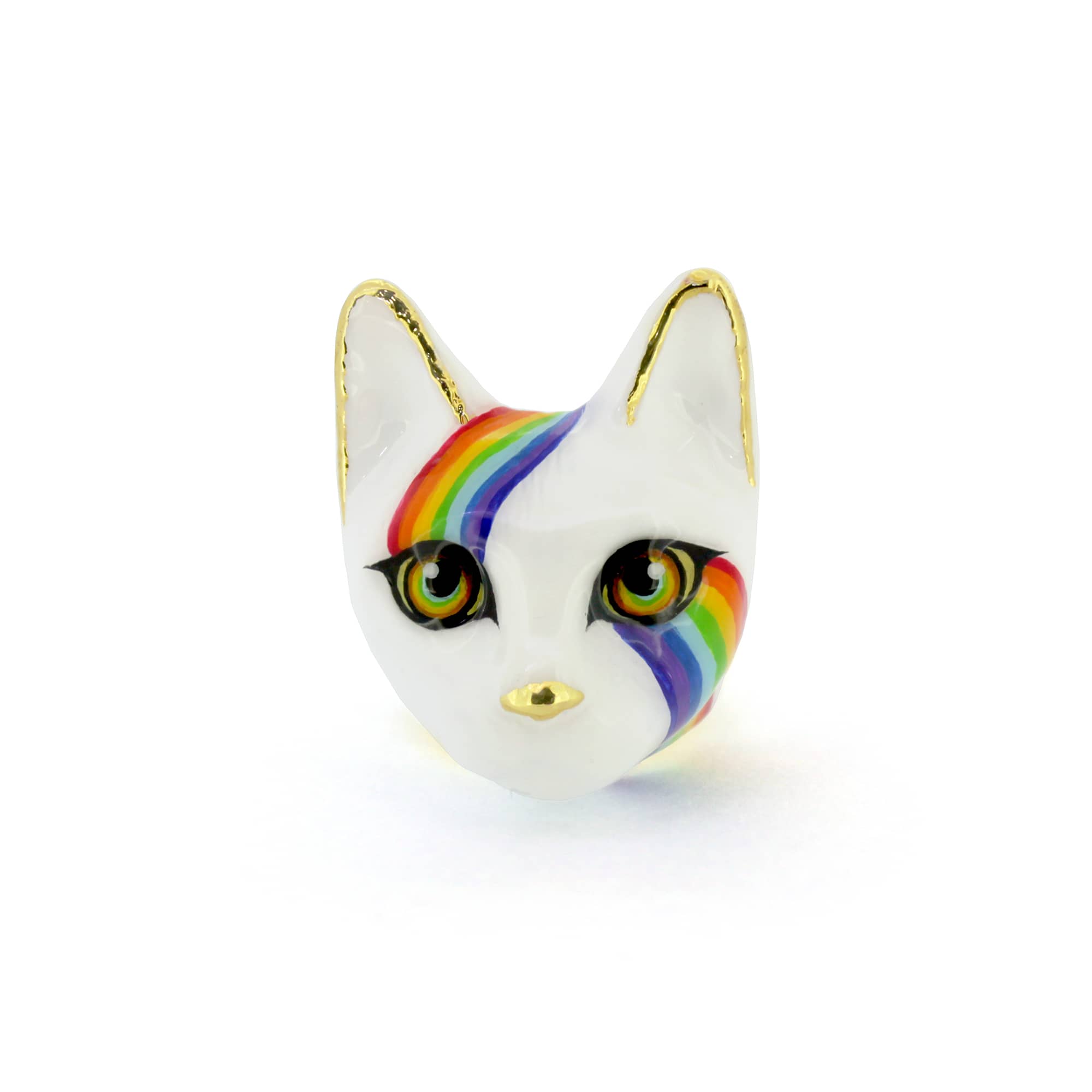 A playful ring designed as a cat's face, featuring a white base, vibrant rainbow stripes across the forehead and cheek and and large eyes.