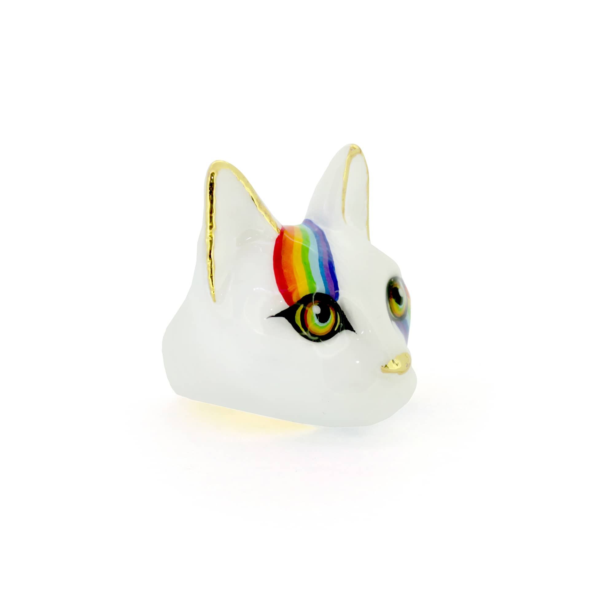 A whimsical ring designed as a cat's face, featuring a white base, vibrant rainbow stripes across the forehead and cheek and and large eyes.