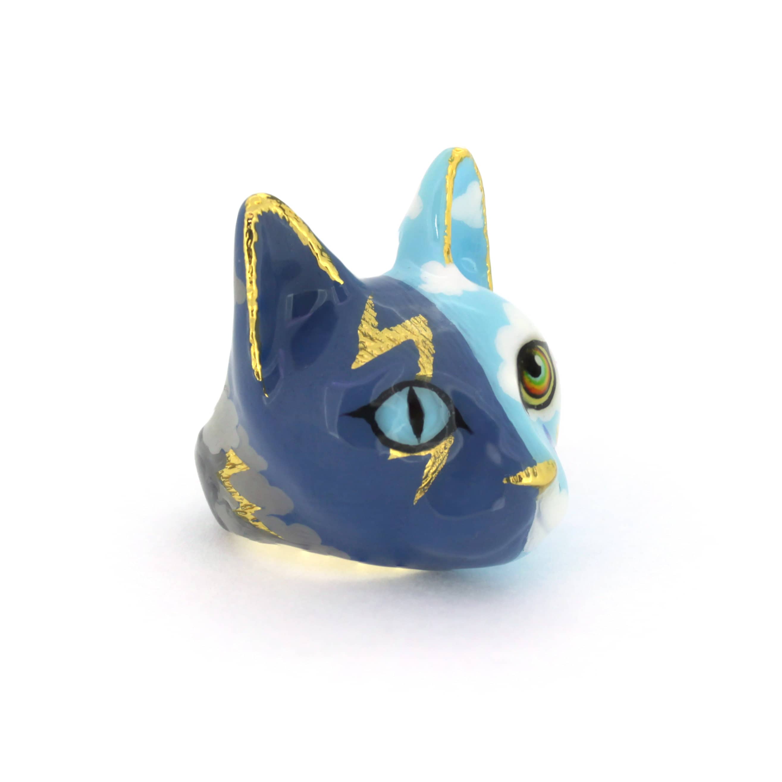 A handcrafted cat ring with an artistic split-face design—half stormy skies with lightning, half bright skies with clouds and a rainbow, perfect for catlovers.