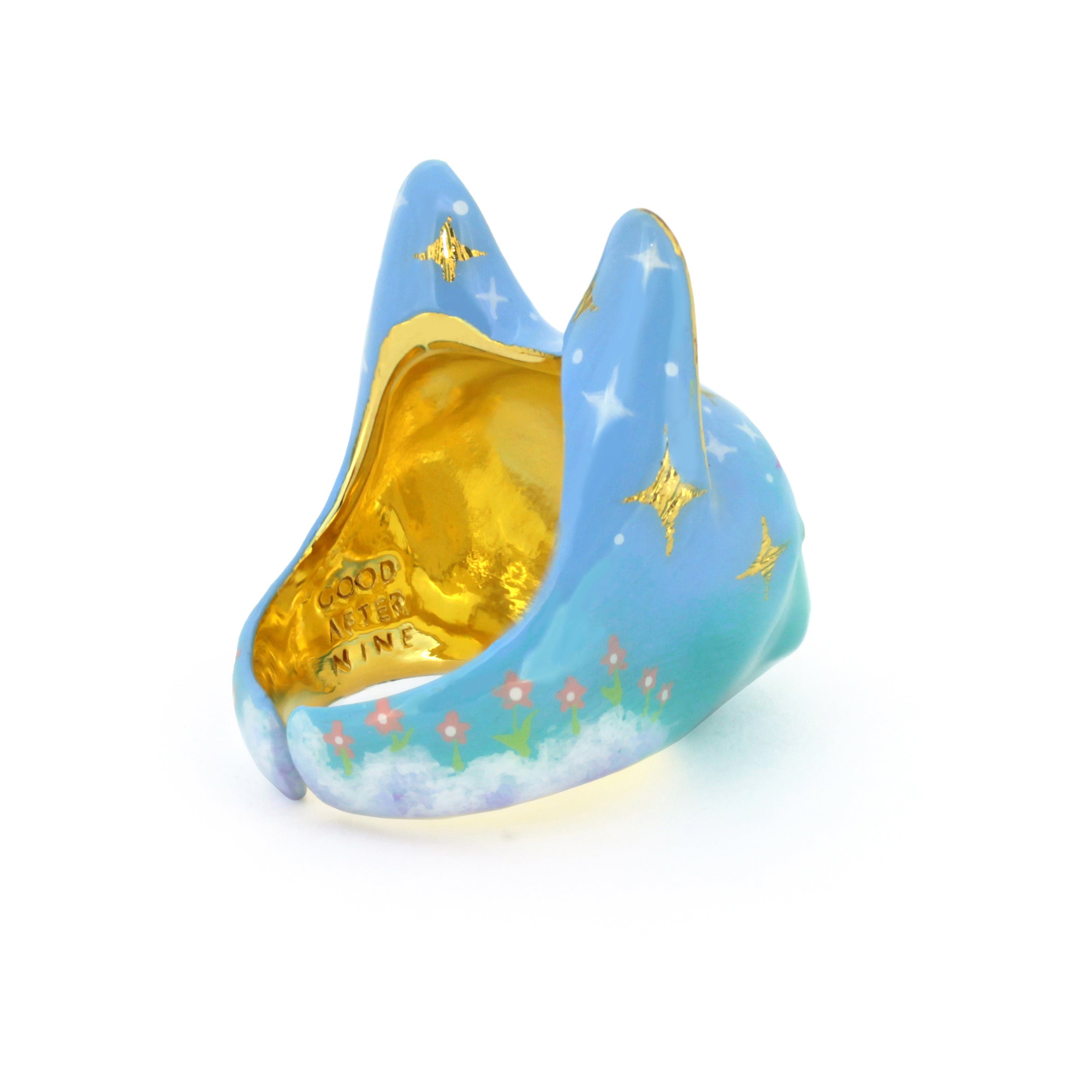 Whimsical ring in a soft blue color featuring star-like patterns, clouds, and pink flowers, perfect for art lovers.