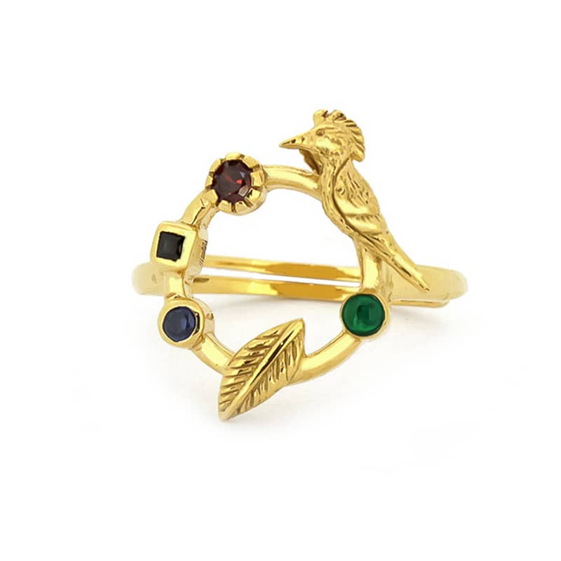A unique golden ring featuring a bird design and various colored stones.