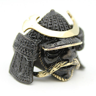 A metal ring designed as a samurai helmet with intricate details, perfect for unique jewelry lovers.