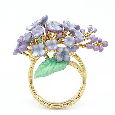 A gold ring featuring vibrant purple flowers and green leaves, perfect for flower lovers.