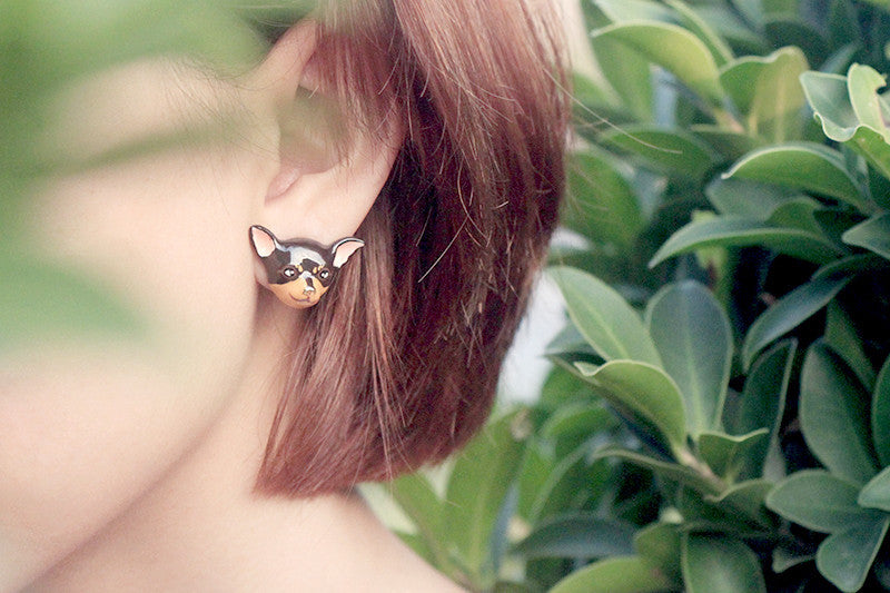 Cute chihuahua earrings worn by a woman with short hair