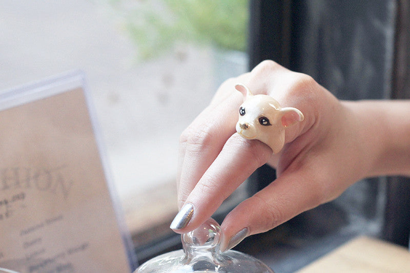 Woman wearing a cute dog ring on her finger.