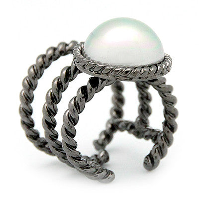 Unique ring with a braided rope design and a moon-like pearl.