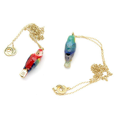 A collection of colorful bird whistle necklaces featuring a parrot, and macaw