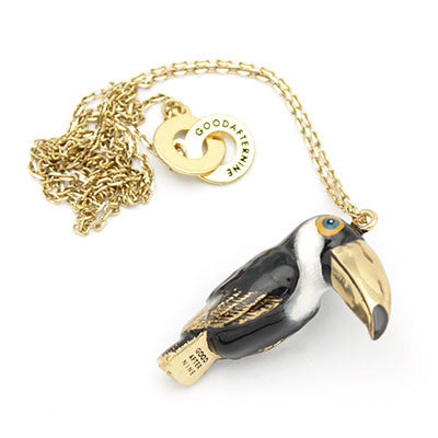 Beautiful toucan-shaped whistle necklace with a gold chain, perfect for bird lovers.