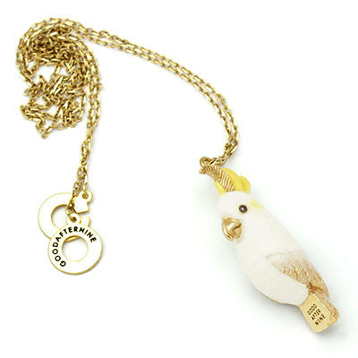 Handcrafted cockatoo-shaped whistle necklace with a gold chain, perfect for animal lovers.