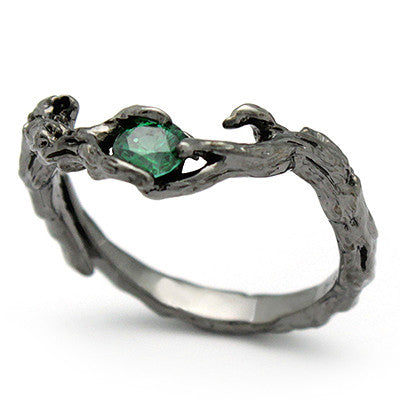Handcrafted ring designed to resemble natural wood, featuring a central green gemstone.