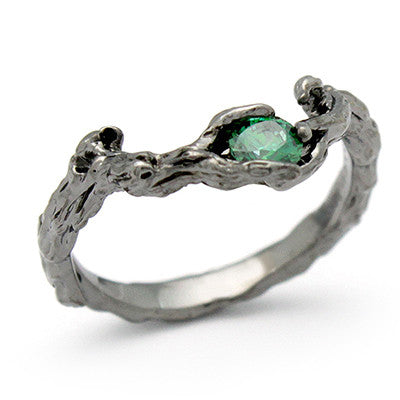 Handcrafted ring designed to resemble natural wood, featuring a central green gemstone.