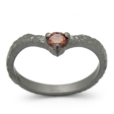 Unique textured ring design featuring a gemstone at the center.