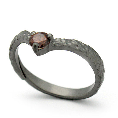 Unique textured ring design featuring a gemstone at the center.