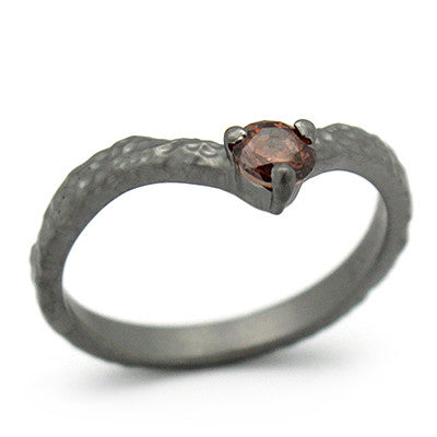 Unique textured ring design featuring a gemstone at the center.