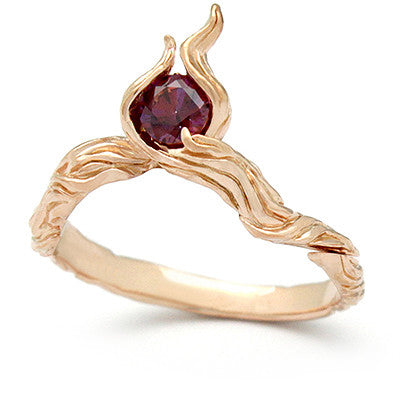 Beautiful ring in rose gold with a flame shape and a gemstone centerpiece.