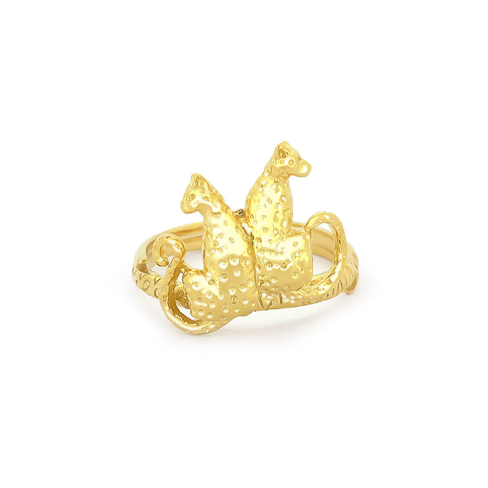 A golden ring featuring two stylized leopards facing each other, adorned with textured detailing and ornate band.