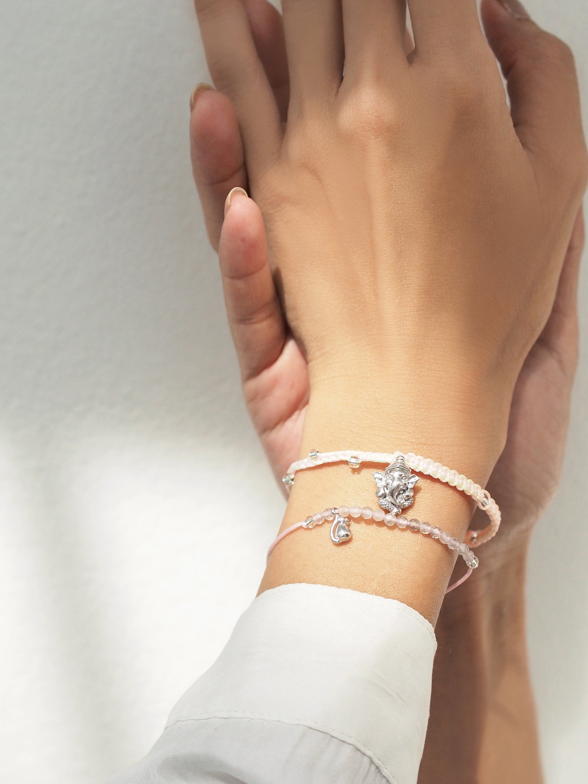 Close-up of Ganesh and Musika bracelet set on a wrist