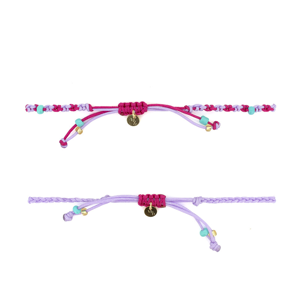 Two bracelets in purple and pink, and turquoise sand beads, featuring a gold Parvati charm and a gold lion charm.