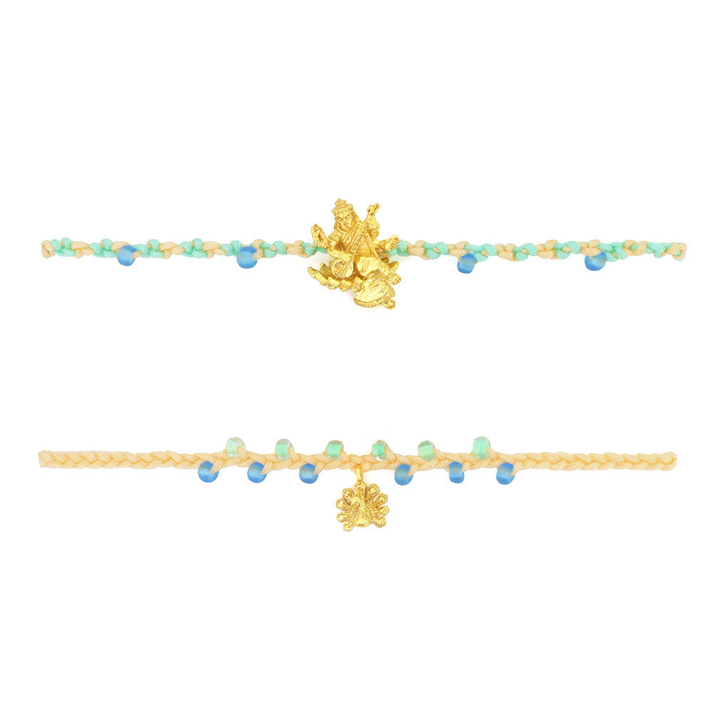 Two bracelets in pastel green and yellow threads with colorful beads, featuring a gold Tridevi Sarasvati charm and a gold peacock charm.