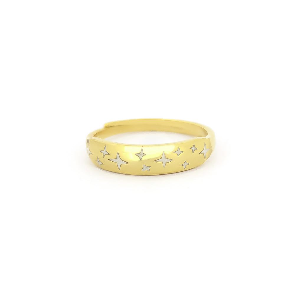 Space-inspired gold ring with stars design on its band.
