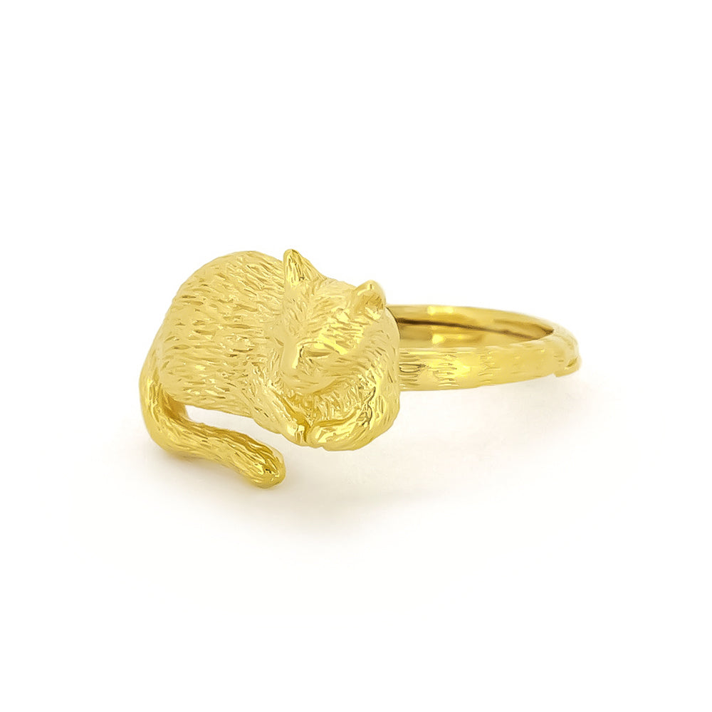 Unique gold ring featuring a sleeping cat design, highlighting their detailed craftsmanship.