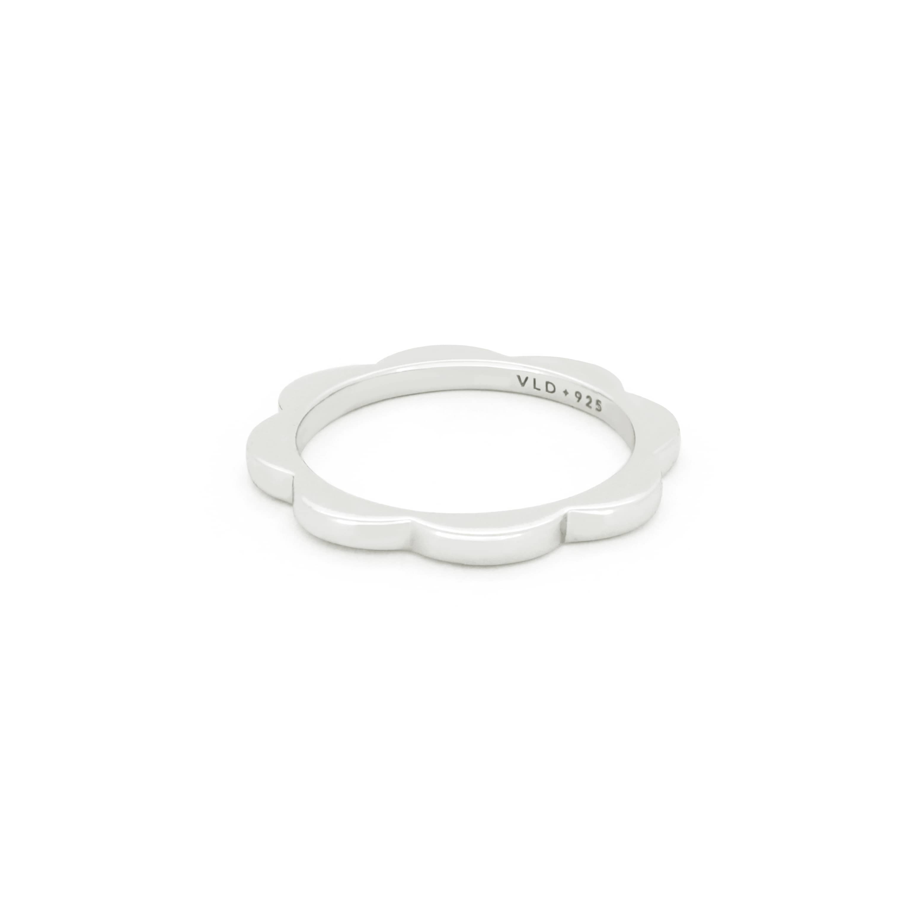 Silver slim stacking ring with a flower design for everyday wear.