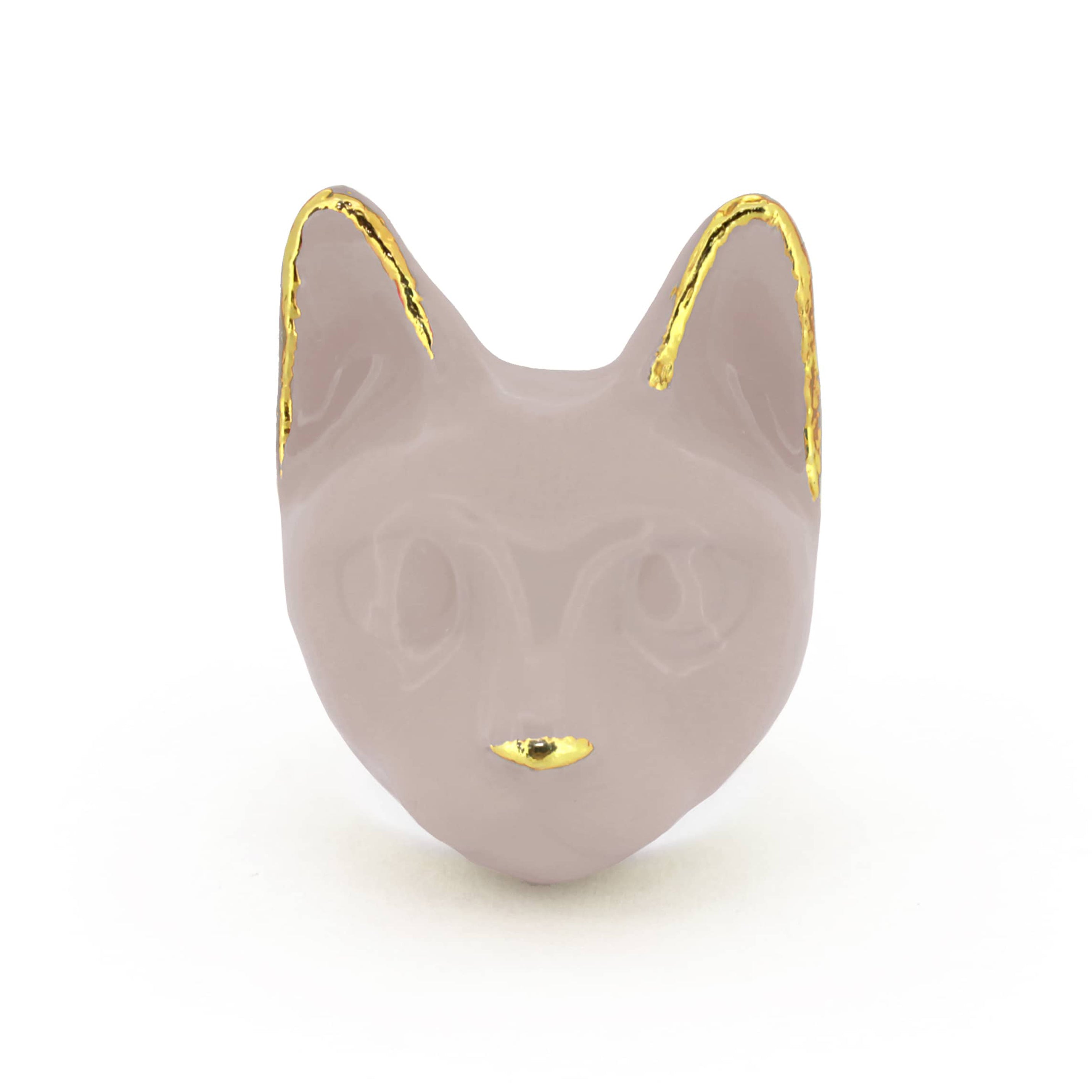 A dusty pink cat's head ring with gold accents on the ears and a small gold nose