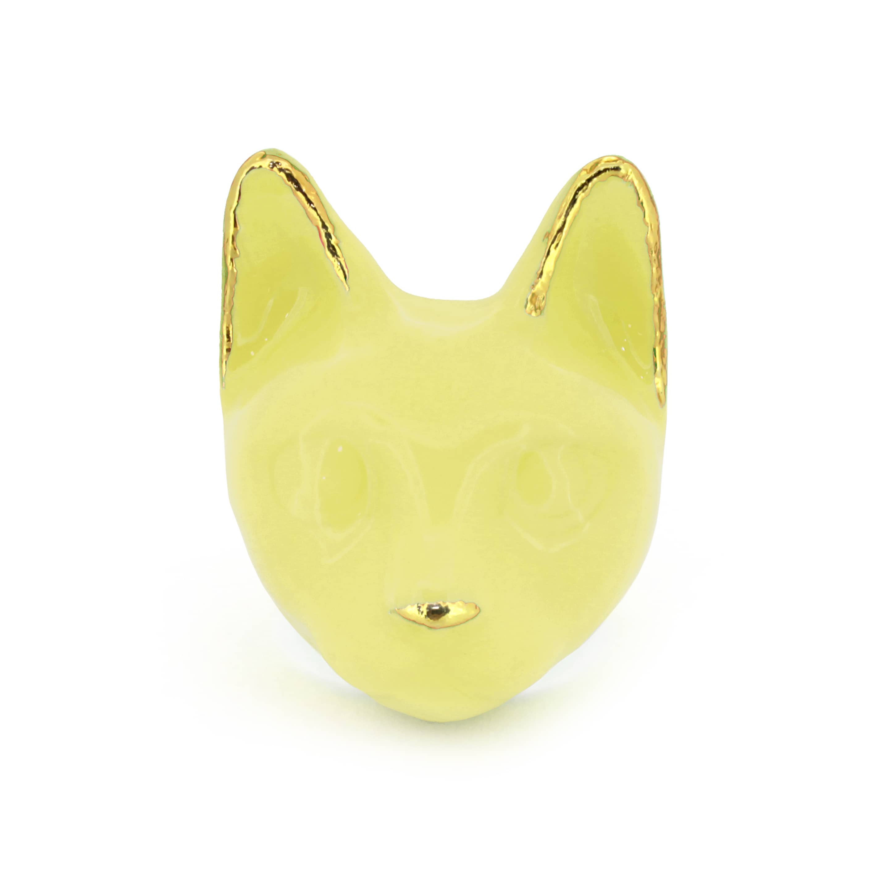 A yellow cat's head ring with gold accents on the ears and a small gold nose