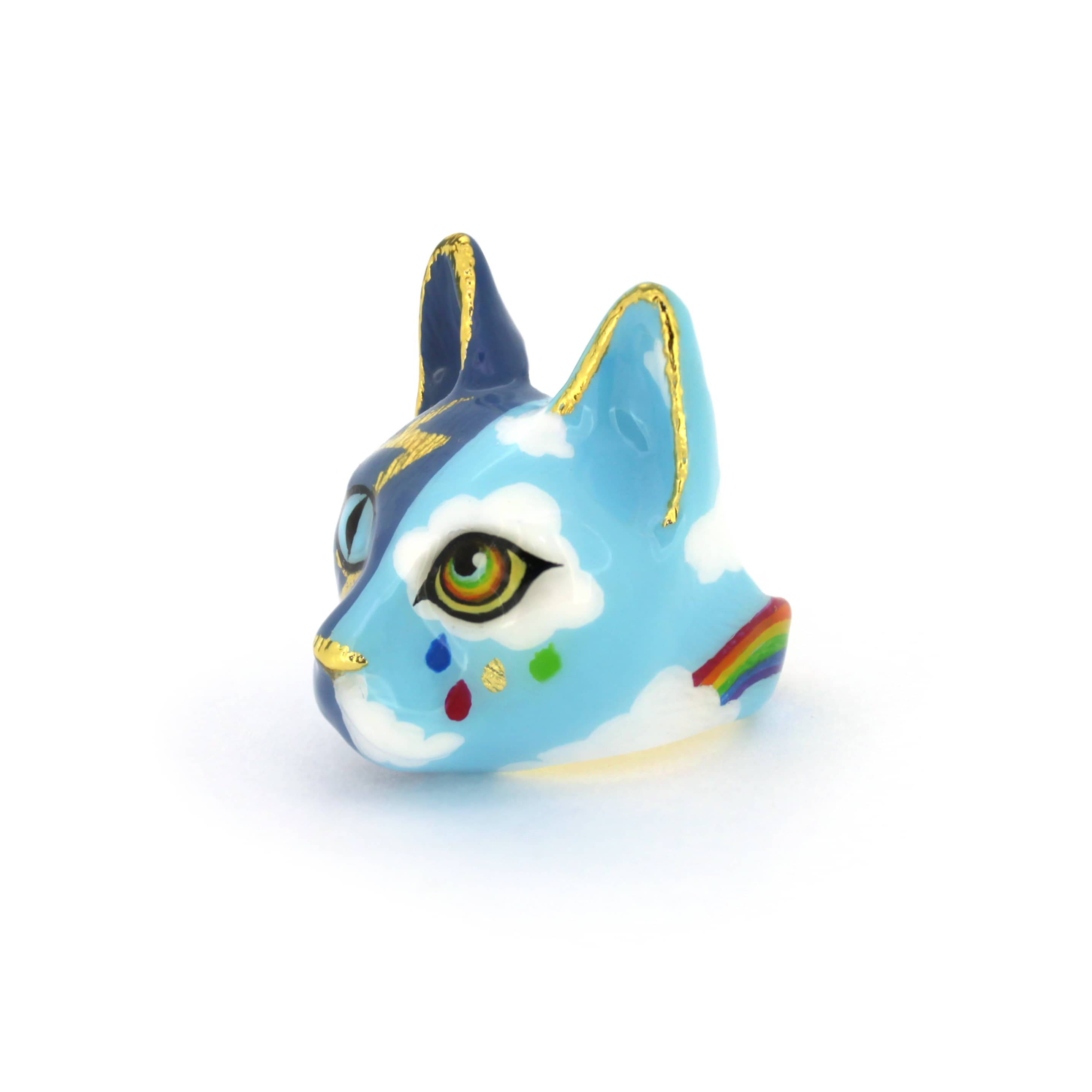 A handcrafted cat ring with an artistic split-face design—half stormy skies with lightning, half bright skies with clouds and a rainbow.