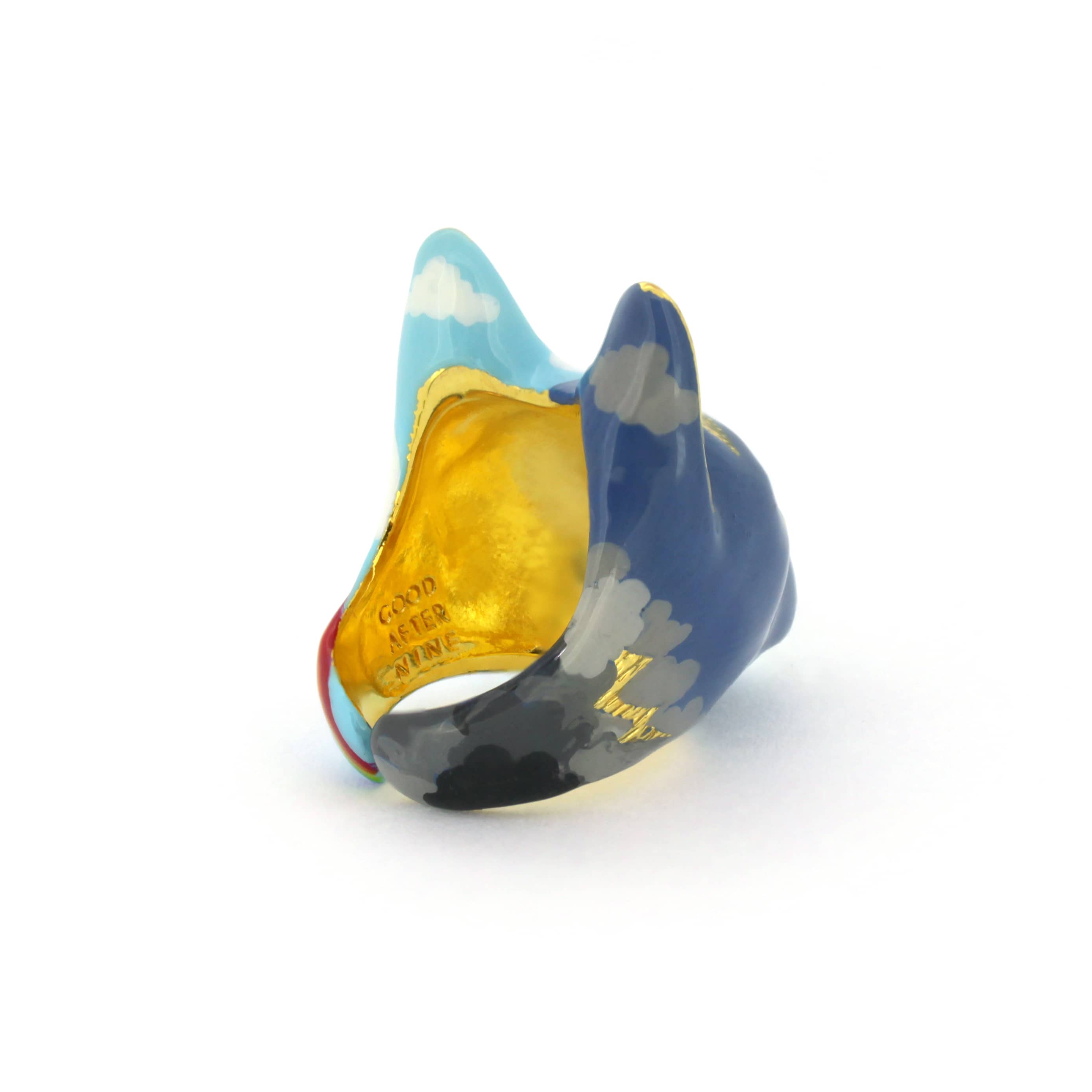 A handcrafted cat ring with an artistic split-face design—half stormy skies with lightning, half bright skies with clouds and a rainbow, perfect for art collectors.