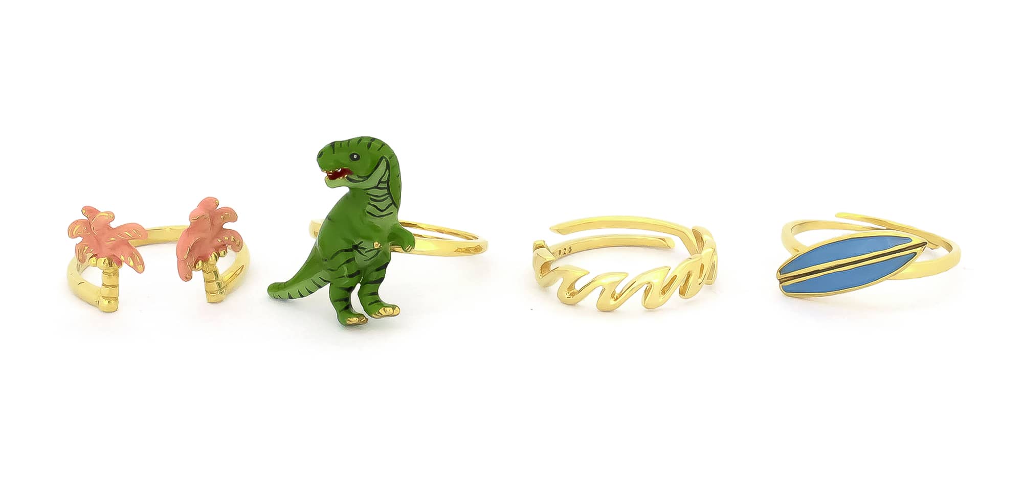 Four playful design rings featuring pink palm trees, a green T-Rex, a wave-pattern, and a blue surfboard design.