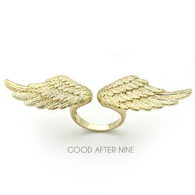 A stylish golden ring featuring intricate wing designs.