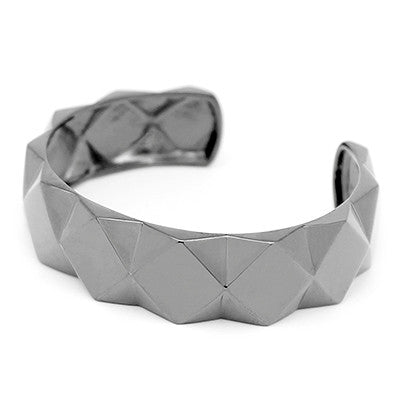 A trendy ring with a bold shape, featuring a unique pyramid design.
