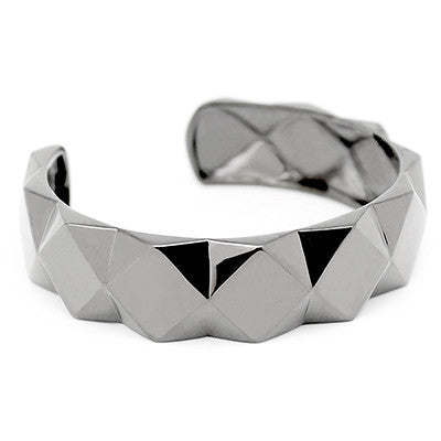 A trendy ring with a bold shape, featuring a unique pyramid design.