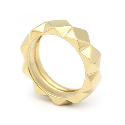 A trendy gold ring with a bold shape, featuring a unique pyramid design.
